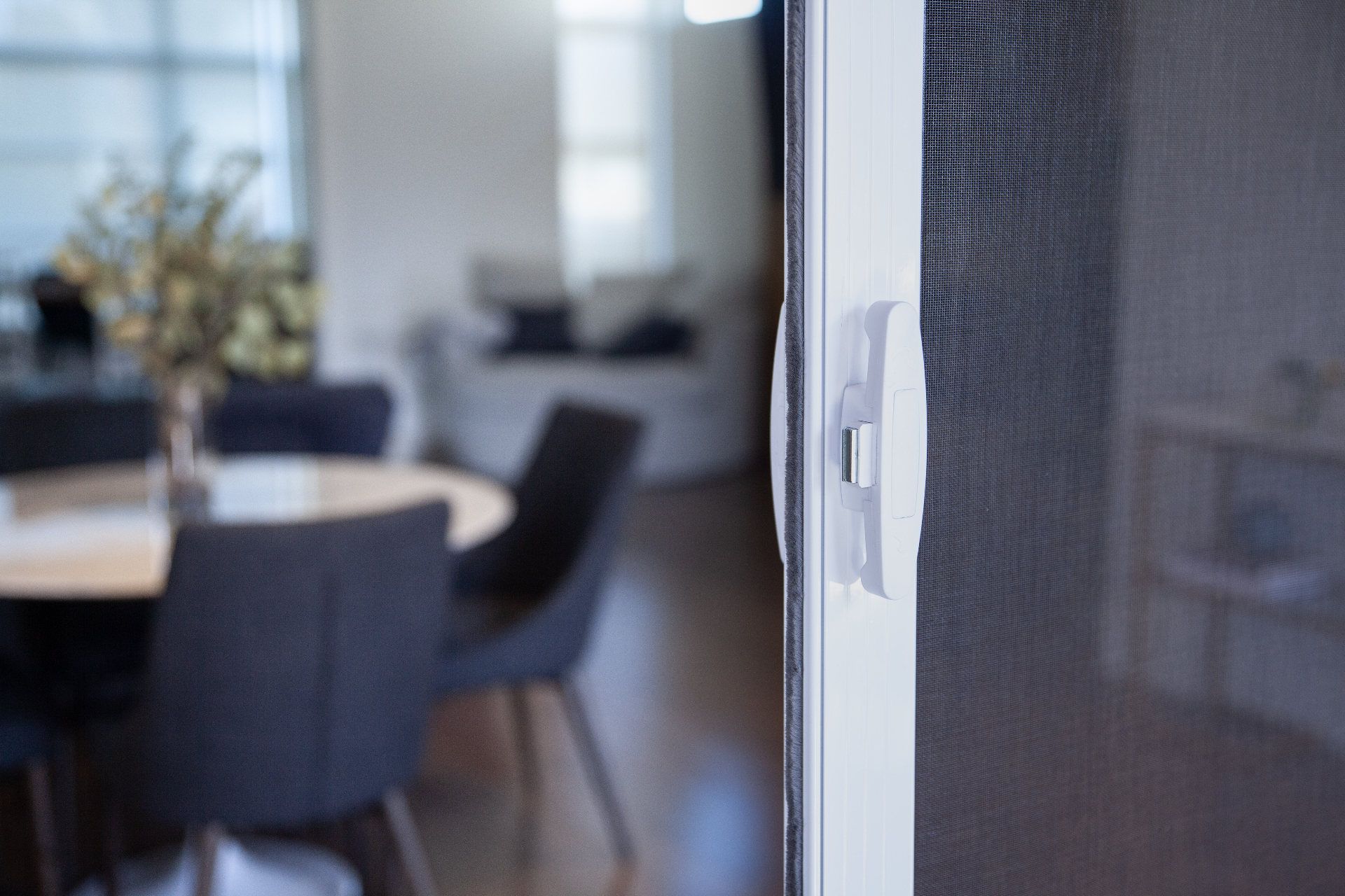 Mirage 3500 bifold screen door with dining room interior view